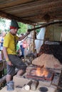 Historic blacksmith with the flame